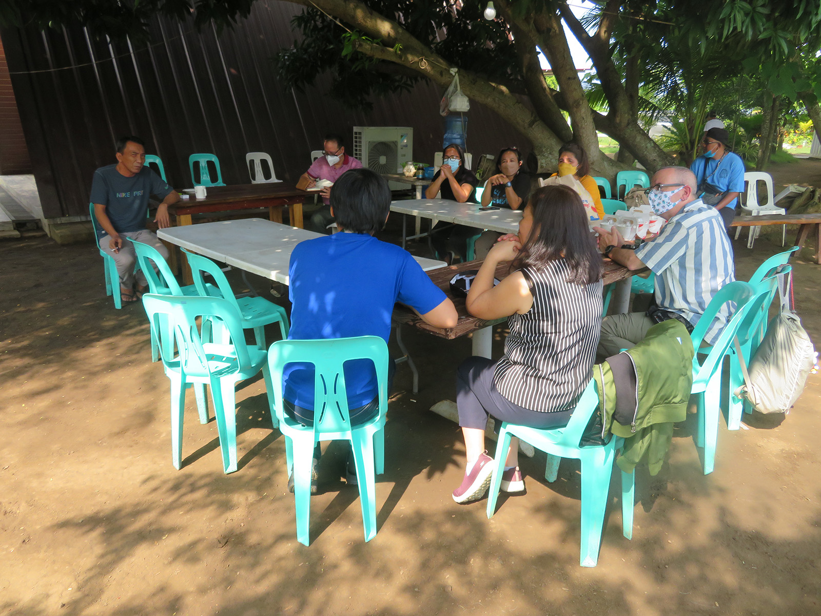 gathering outside in aqua plastic chairs